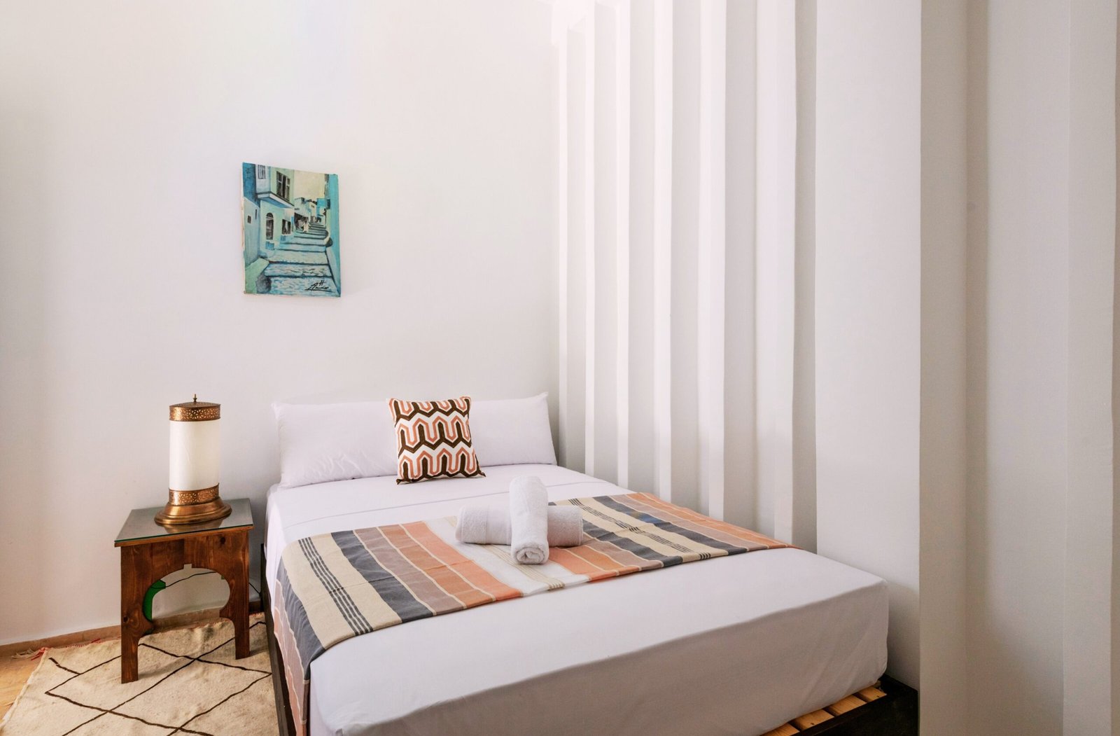 Earthy tones and carved wood reflect Moroccan heritage.